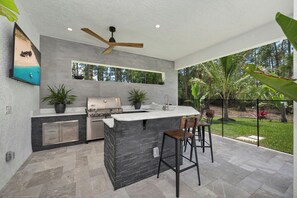 Terrace/patio - Luxurious 2024 5-BR House-- Heated Pool and Outdoor Kitchen, just minutes from beaches and downtown (Naples)