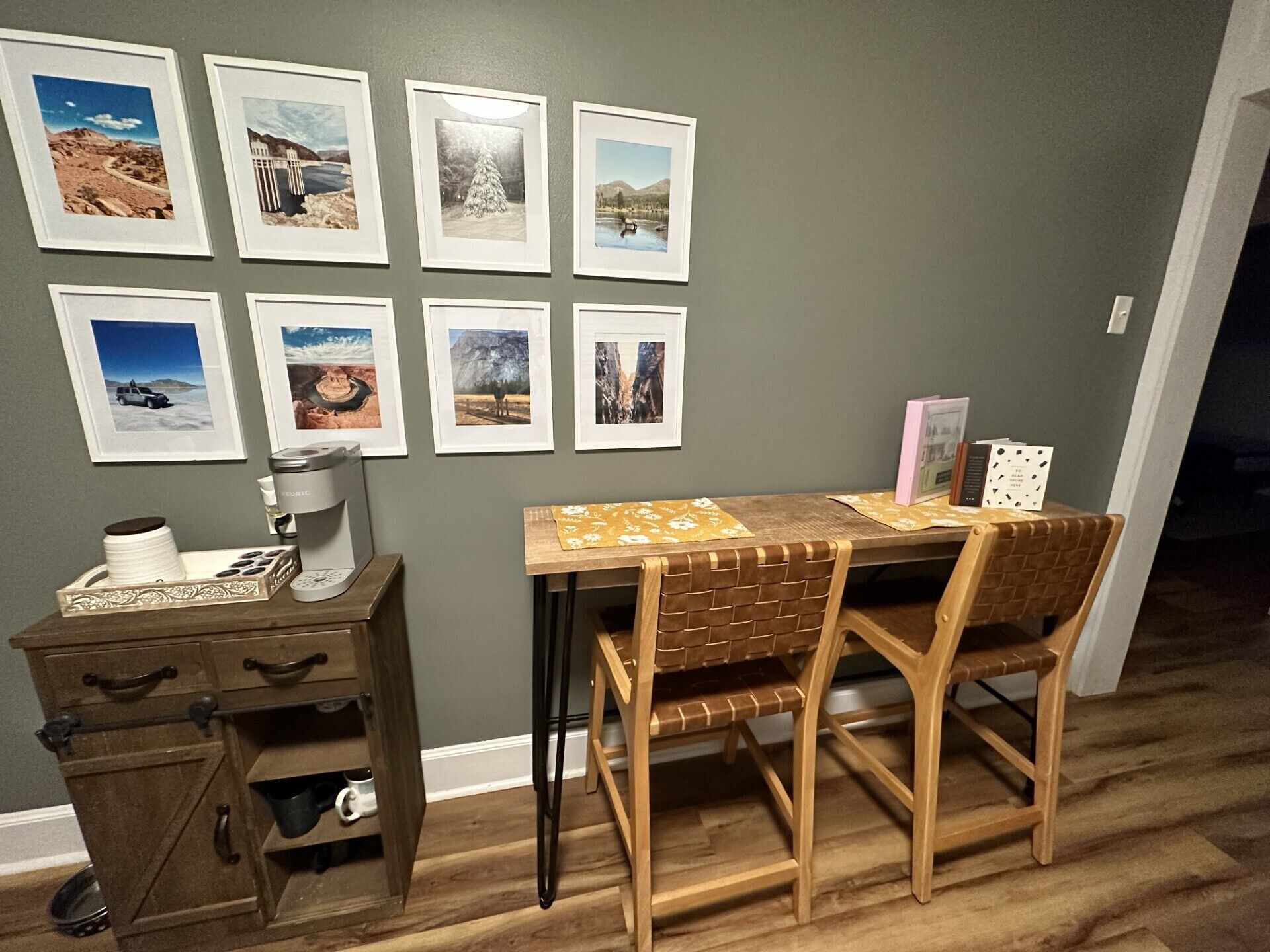 Un coin repas avec une table et des chaises en bois, une machine à café et un meuble avec des tiroirs.