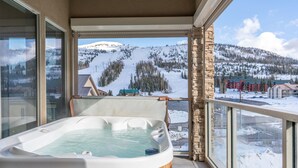 A hot tub on a balcony with a view of a snowy mountain landscape. - 3min Walk to Ski Lift*Hot Tub*Epic Kids Room*Views (Brian Head)