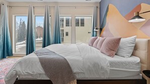 A bedroom with a bed, a view to the outside, and a wall with a geometric design. - 3min Walk to Ski Lift*Hot Tub*Epic Kids Room*Views (Brian Head)
