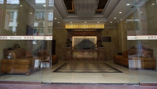 A lobby with a reception desk, a large chandelier, and leather sofas. - Hongyan Business Hotel (Baoxing)