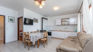 A compact living space with a dining area, kitchenette, and a sofa. - Gorgeous home in Dobropoljana (Dobropoljana)