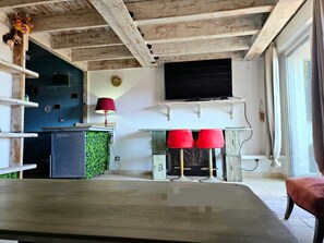 Cozy retreat with a flat-screen TV, kitchenette, and comfortable seating area.