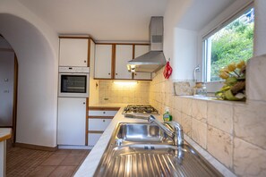 Fridge, dishwasher, coffee/tea maker, cookware/dishes/utensils