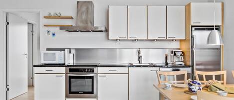 Fridge, stovetop, dishwasher, coffee/tea maker