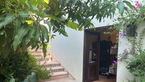 A stone-paved courtyard with a tiled staircase leading to a room. - Charming 5-bed house with sweeping ocean views in delightful San Jose Del Cabo. (San Jose Del Cabo)