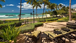 A beachside lounge with wicker chairs and a view of the ocean. - Fall Specials & Sales now-OT305-Beautiful 3 bed, 2.5 bath (Kapolei)
