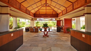 A spacious lobby with a high ceiling, a central table, and a reception desk. - Fall Specials & Sales now-OT305-Beautiful 3 bed, 2.5 bath (Kapolei)
