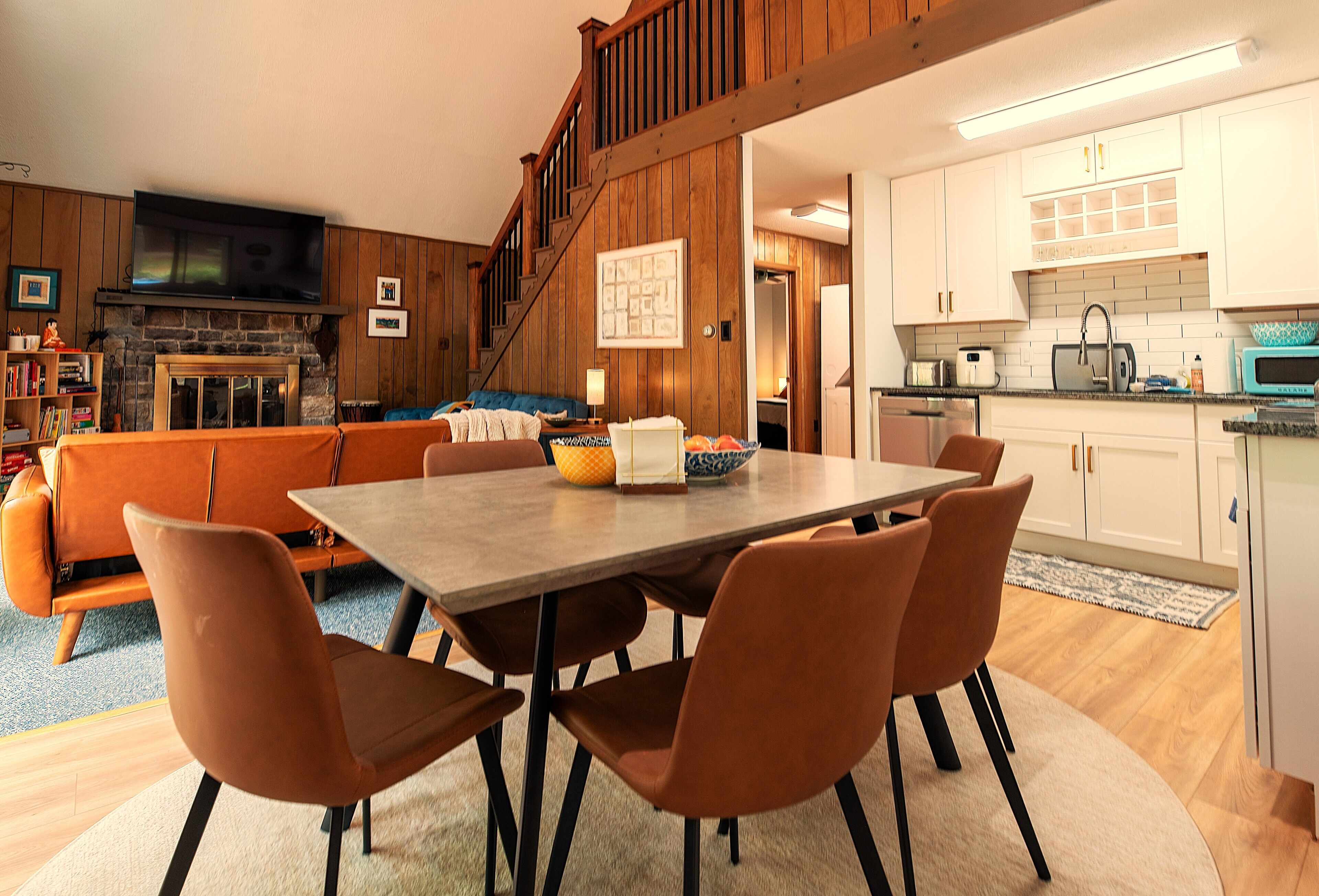 A modern kitchen with white cabinets, a microwave, and a toaster.