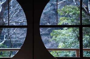 Panoramic views of lush foliage are framed by a unique, symmetrical window design.