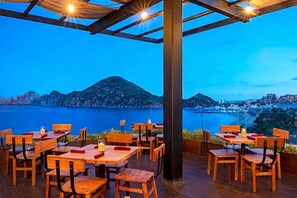 Enjoy al fresco dining with a view of the ocean and surrounding mountains.