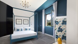 A modern bedroom with a four-poster bed, a flat-screen TV, and a view of the outdoors. - Design flat - Pesce (Piano di Sorrento)