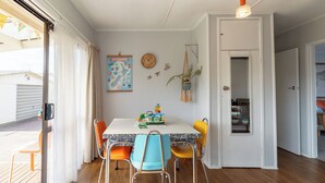 A dining area with a table, chairs, a clock, a map, and a plant. - ◇◇NO CLEANING FEE◇◇
Cottage135 Rotorua - Family-friendly holiday home (Rotorua)
