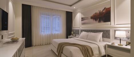 Una habitación de hotel moderna con una cama grande, televisor, escritorio y un cuadro en la pared.