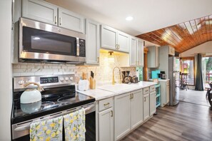 Microwave, oven, stovetop - Cozy lake front cottage in Baldwin, MI with hot tub! (Baldwin)