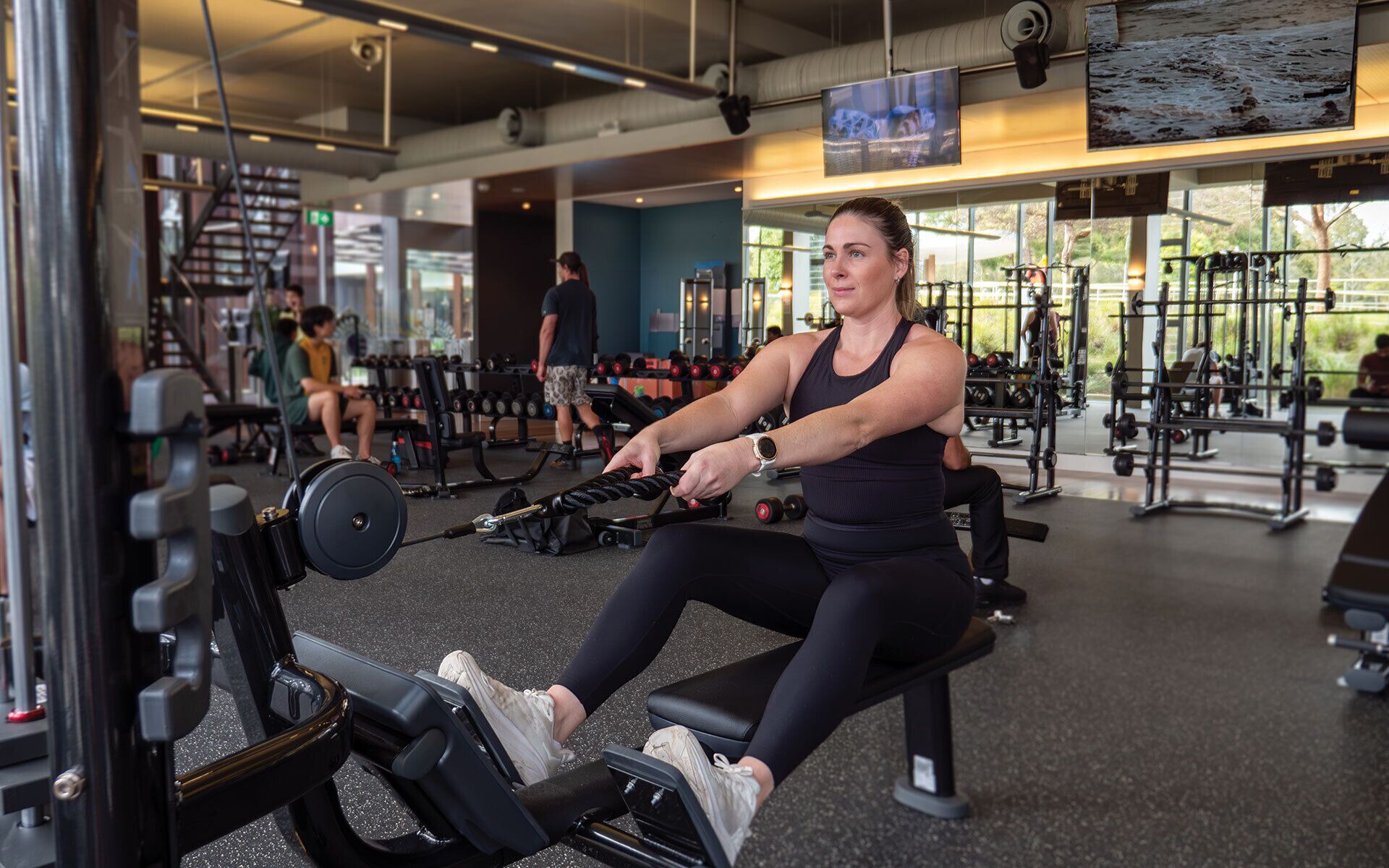 A gym with various exercise equipment, including treadmills and weight machines.