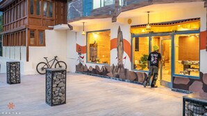 A building with a wooden facade, large windows, and a balcony. - Zostel Kalpa (Kalpa)