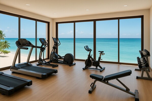 A gym with various exercise equipment and large windows overlooking a beach. - JAZ Elite Adonia (Uroa)