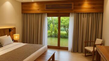 A hotel room with a large bed, a desk, a chair, and a view of a garden through the window.