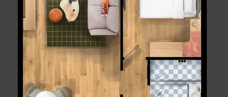 A top-down view of a room with a sofa, a bed, a small kitchen area, and a dining table.