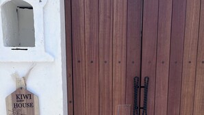 Une porte en bois avec une poignée en métal et une petite plaque en bois fixée au-dessus.