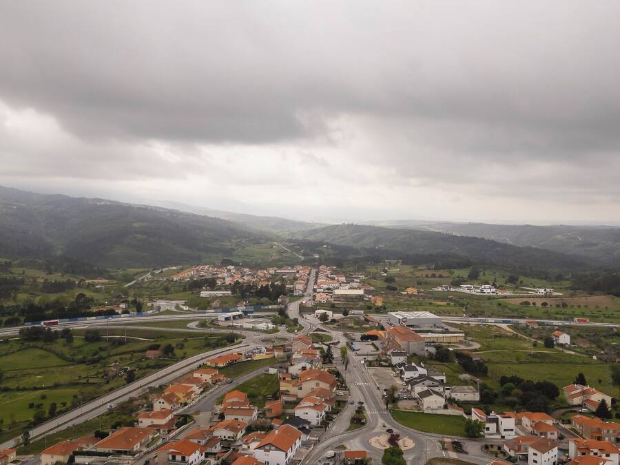 Uma área residencial com casas, ruas e uma autoestrada.