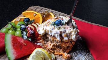 A dessert with fruit and a spoon.