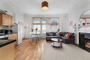 A modern living space with a kitchen, dining area, and seating area. - Athenaeum Pl N10 | Muswell Hill | First Floor 1BD (London)