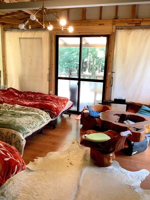 A room with a bed, a wooden chair, a rug, and a large window. - kasibessou guranpingu himesyara  (Kirishima)