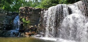A waterfall cascading over a rocky cliff into a pool.