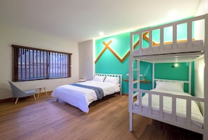 A modern bedroom with a bunk bed, a single bed, a desk, and a chair.