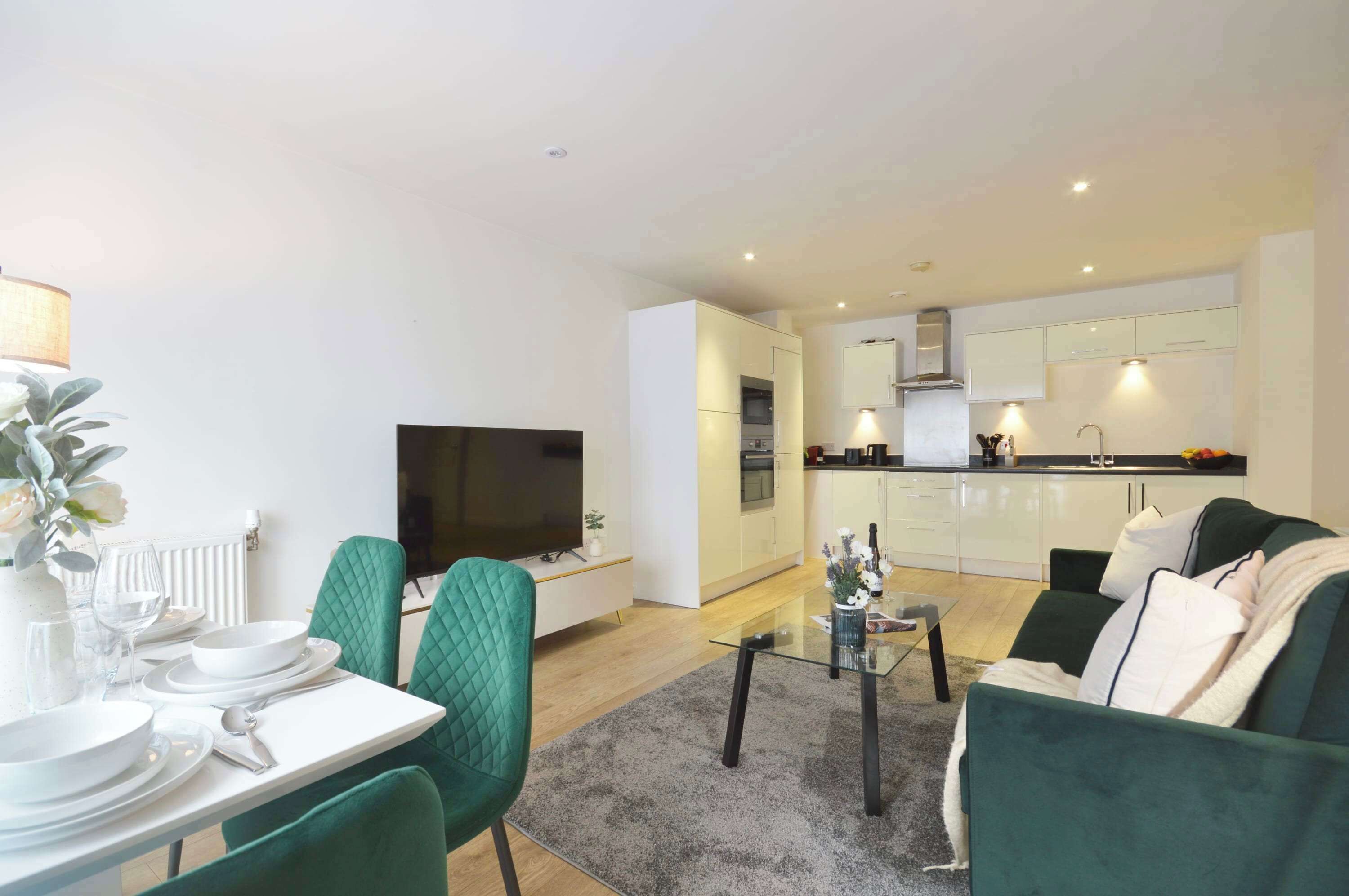 A modern apartment with a dining area, a living room, and a kitchen.