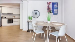 A modern kitchen with white cabinets, a wooden countertop, and a built-in oven. - Kipseli New Modern Cosy Apts Apt No 5 (Athens)