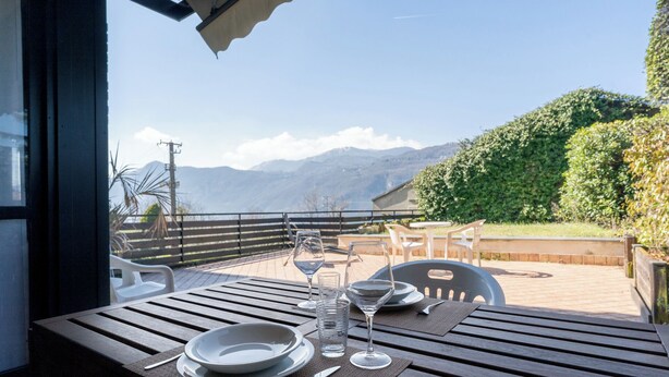 A table set outdoors with a view of mountains. - SunsetView - Lake Como swimming pool and garden (Lierna)