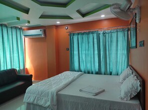 Premium bedding, desk, laptop workspace, bed sheets - Raj Hotel (Baksa)