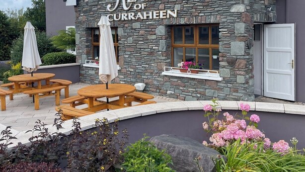 Ein Steinhaus mit einem Schild, auf dem 'Keanes of Curragheen' steht.