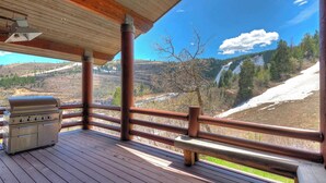 A wooden deck with a grill and a bench, overlooking a mountainous landscape. - La Maconnerie Cabin - Ski In-Ski Out (Park City)