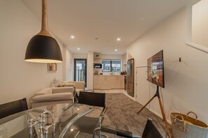 A modern interior with a dining area, kitchen, and living space. - Central City Boutique Escape (Christchurch)
