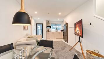 A modern interior with a dining area, kitchen, and living space.