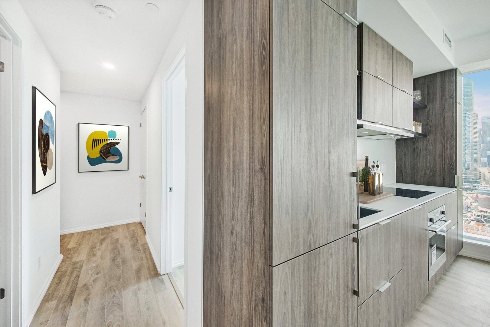 A modern kitchen with wooden cabinets and a city view.