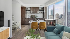 A modern apartment with a dining area, kitchen, and living room. - The Mason (Toronto)