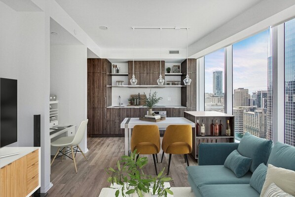 A modern apartment with a dining area, kitchen, and living room. - The Mason (Toronto)