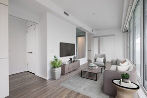 Panoramic, City View | Living area | 50-inch TV with cable channels
