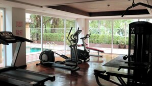 A gym with treadmills, elliptical machines, and weight equipment. - 6-49 - 1 Bdr Condo with Balcony and shared Pool (Tambon Patong)