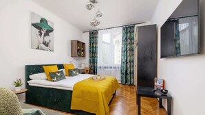 Ein modernes Schlafzimmer mit Bett, Nachttisch, Spiegel und einem Fenster mit Vorhängen.