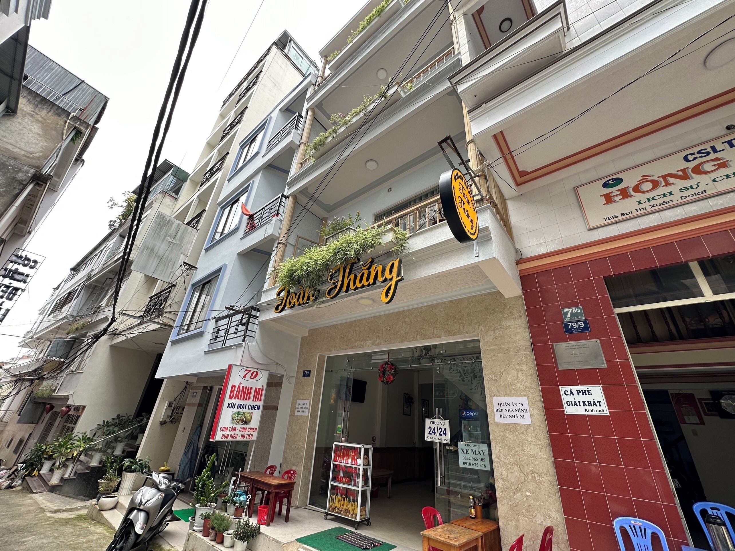 A storefront with a sign that reads 'Thang' and a visible entrance.