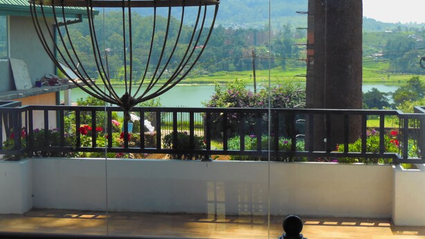A balcony with a view of a lake and mountains.