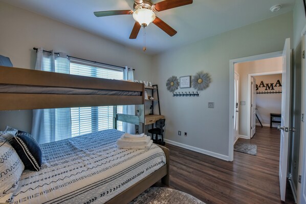 A bedroom with a bunk bed, a desk, and a ceiling fan. - Crimson Corner - Book for Football Season! (Tuscaloosa)
