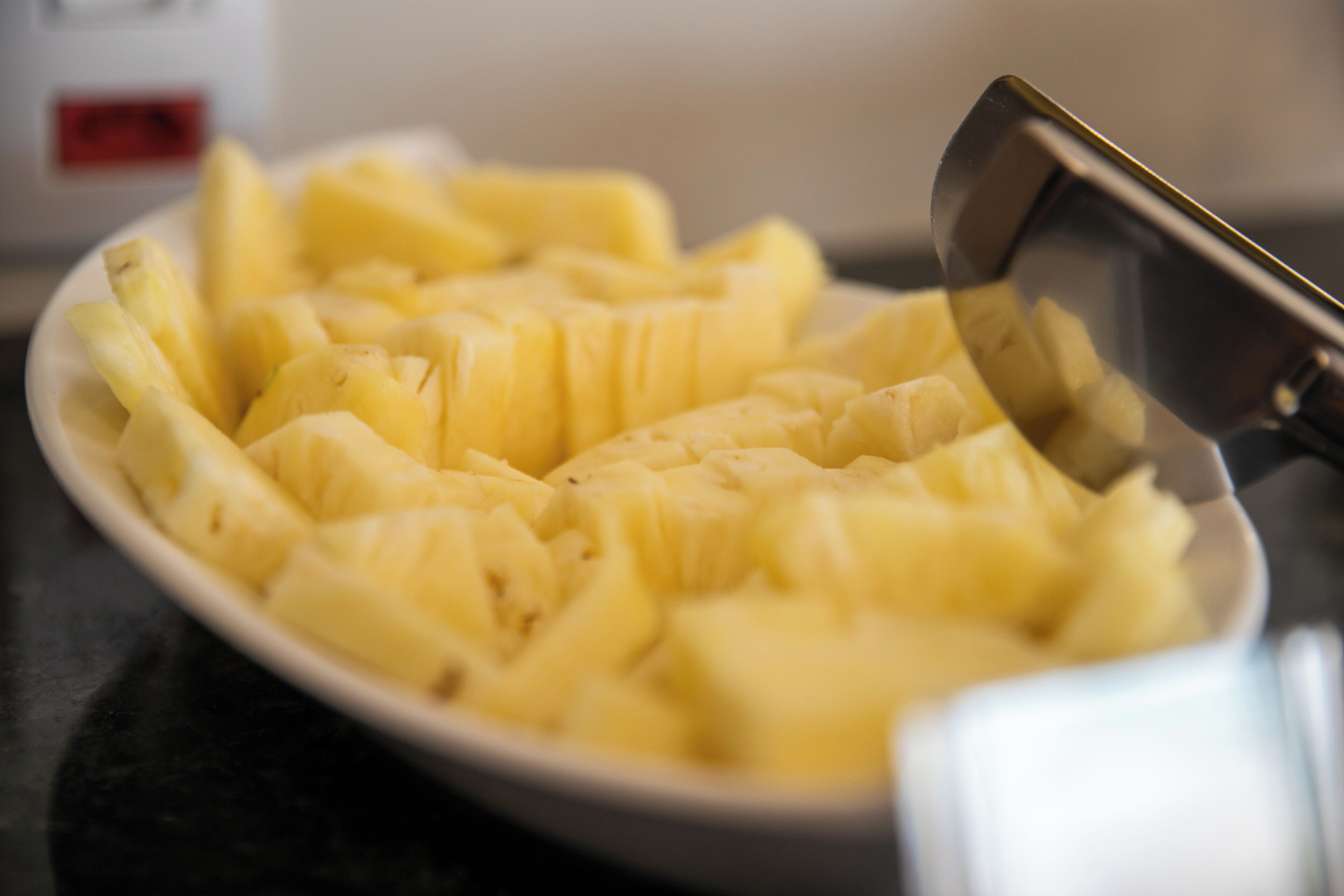 A white plate with sliced bananas.