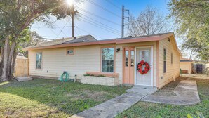A single-story house with a front door, a small porch, and a front yard. - Dog-friendly San Antonio Home ~ 7 Mi to Downtown! (San Antonio)